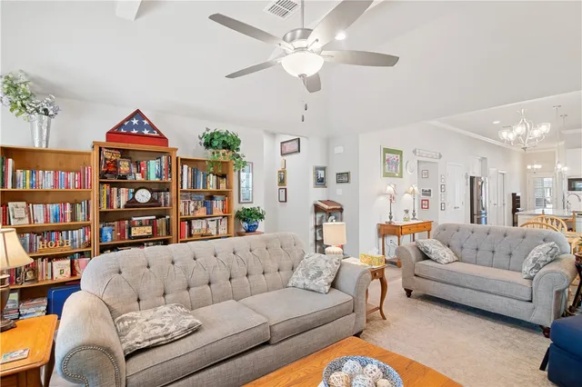 a living room with furniture a rug and a book shelf