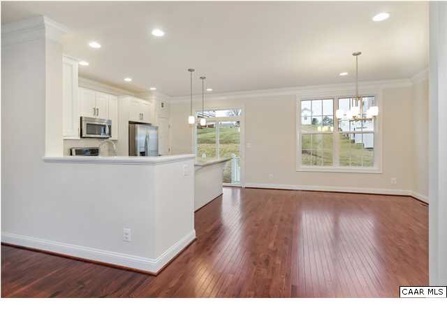2106 Avinity Loop Charlottesville, VA 22902 - Photo 3 of 18 a room with stainless steel appliances kitchen island wooden floors and view living room