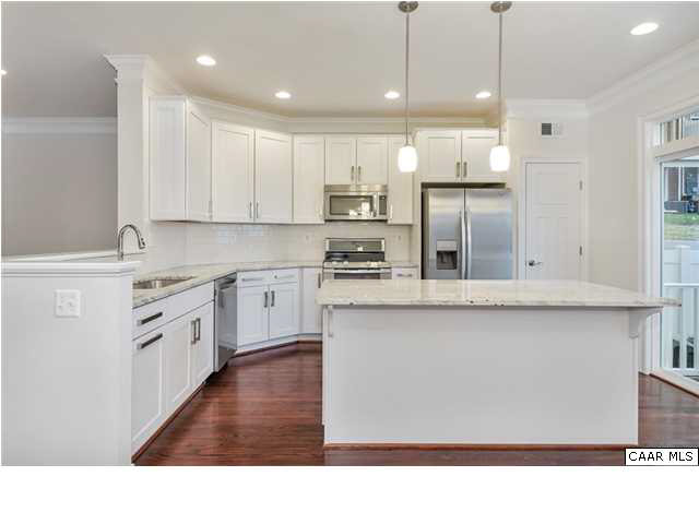 2106 Avinity Loop Charlottesville, VA 22902 - Photo 5 of 18 a kitchen with stainless steel appliances granite countertop a sink a stove top oven a refrigerator and white cabinets