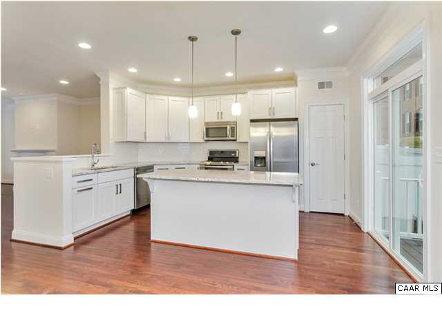 2106 Avinity Loop Charlottesville, VA 22902 - Photo 7 of 18 a kitchen with stainless steel appliances granite countertop a stove top oven a sink and a refrigerator