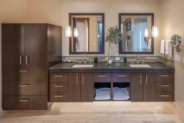 a bathroom with a granite countertop sink and a mirror