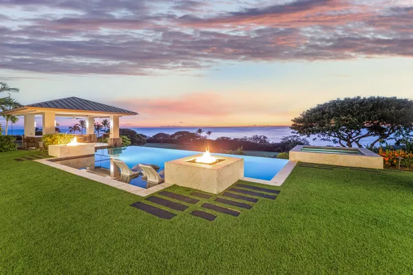 a view of a garden with lawn chairs