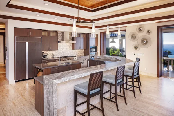 a dining hall with stainless steel appliances granite countertop a dining table and chairs with wooden floor
