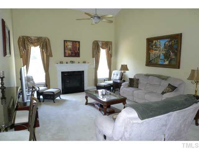 316 Powers Ferry Road Cary, NC 27519 - Photo 8 of 25 The dramatic and impressive 2-story family room features a gas log fireplace surrounded by beautiful tall windows overlooking the lush backyard, a ceiling fan and a small bar that transitions from the kitchen and breakfast rooms. Den/Family/Great Room