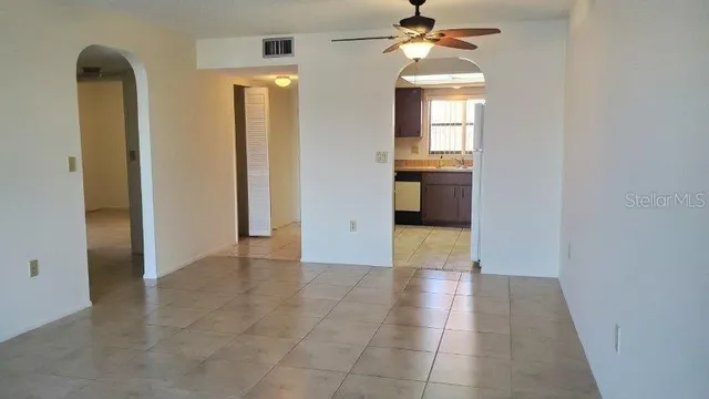 a view of a hallway with wooden floor and a chandelier