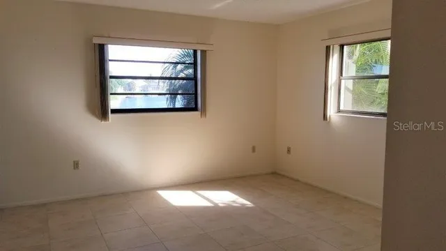 an empty room with windows and closet