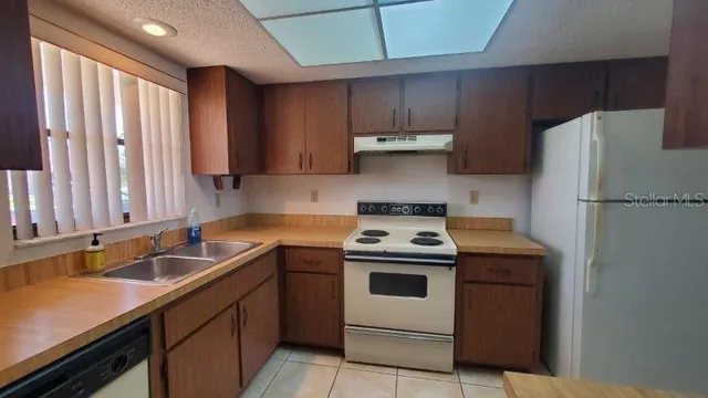 a kitchen with a stove sink and refrigerator