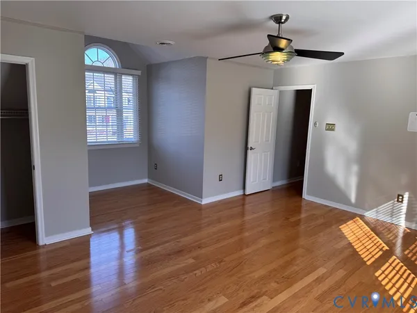 an empty room with wooden floor and door