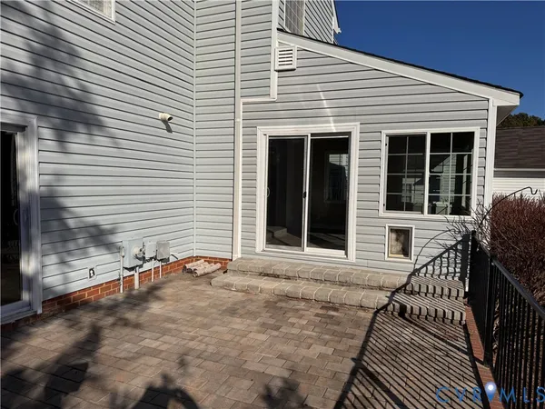 a view of a house with a yard and wooden fence