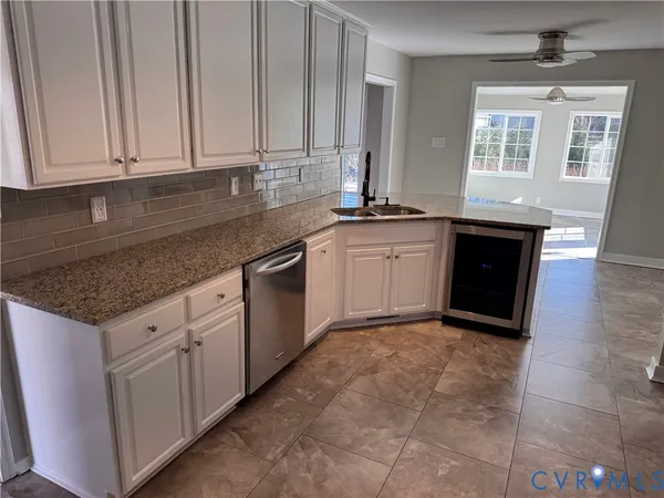 a view of a kitchen with a sink and refrigerator