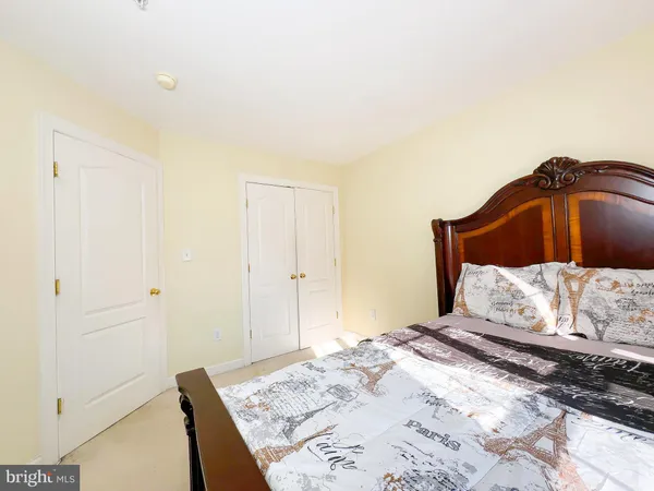 a bedroom with a bed and a mirror