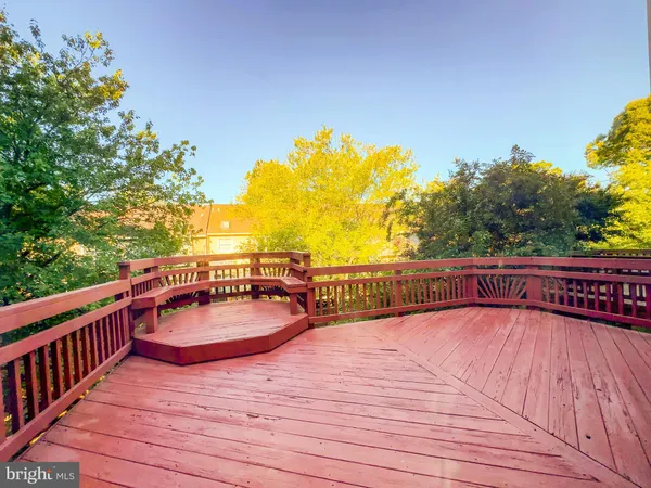 a view of balcony with wooden floor and seating space