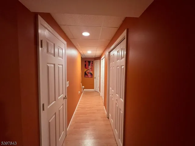 a spacious bedroom with a bed and wooden floor