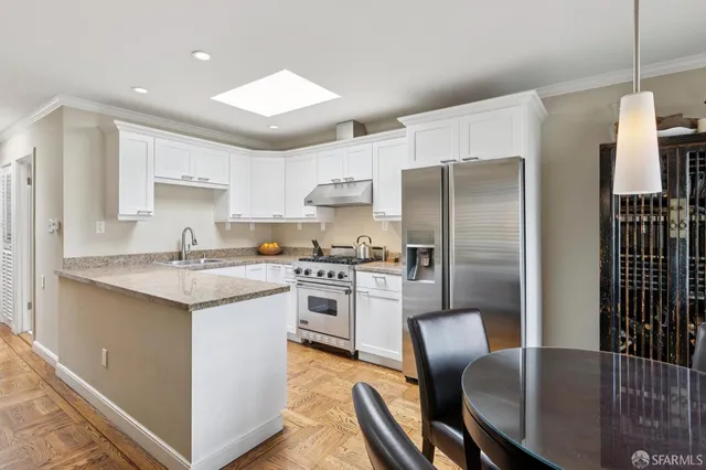 a bathroom with a sink a toilet a mirror and shower