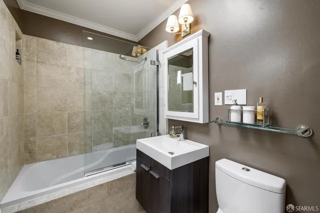 a roof deck with table and chairs under an umbrella