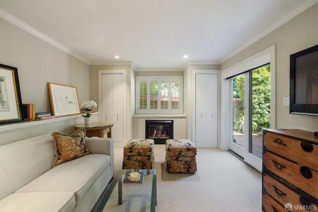 a pathway of a house with potted plants in front of door