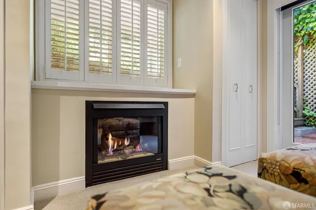 a roof deck with table and chairs under an umbrella