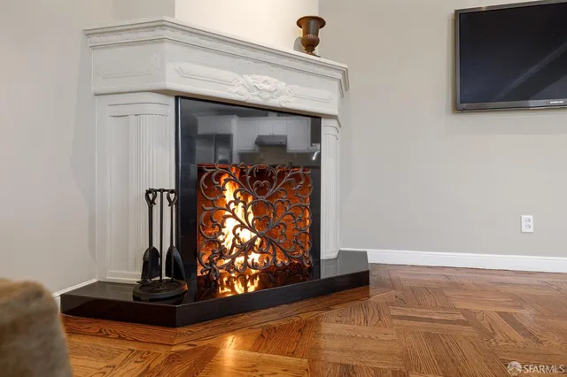 a kitchen with a refrigerator a stove a sink and chairs