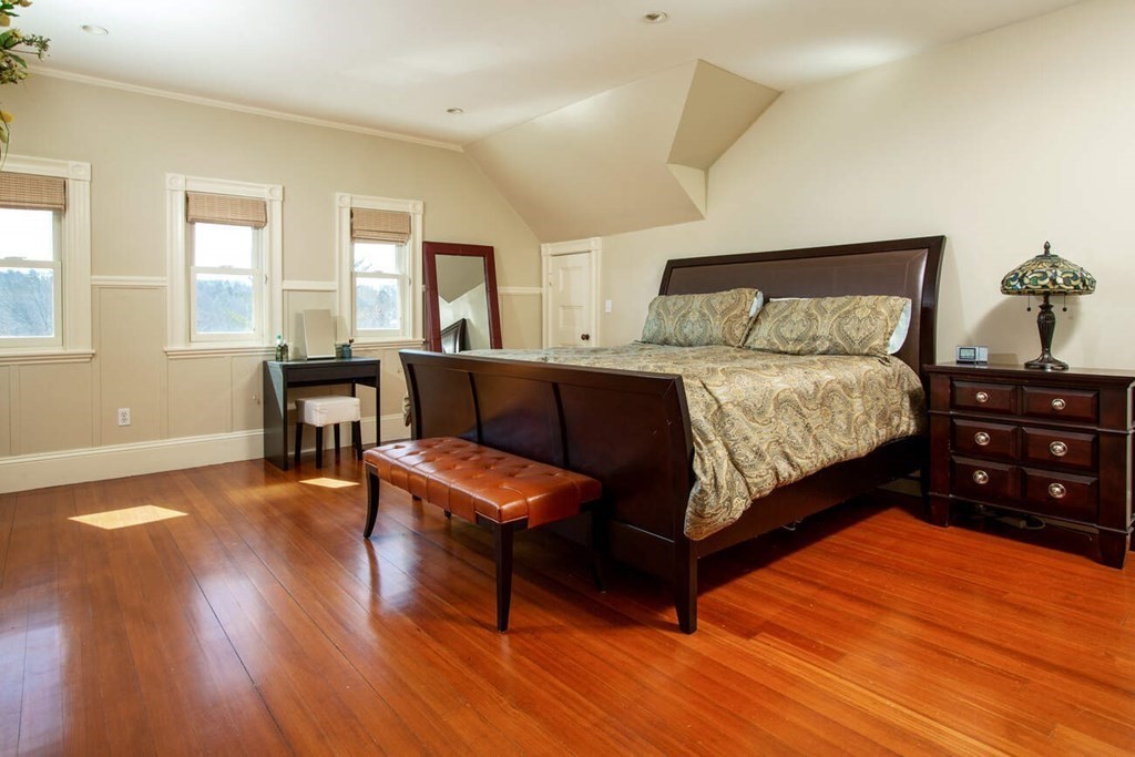 145 Salisbury Road, Unit 145 Brookline, MA 02445 - Photo 12 of 17 a bedroom with a bed and wooden floor