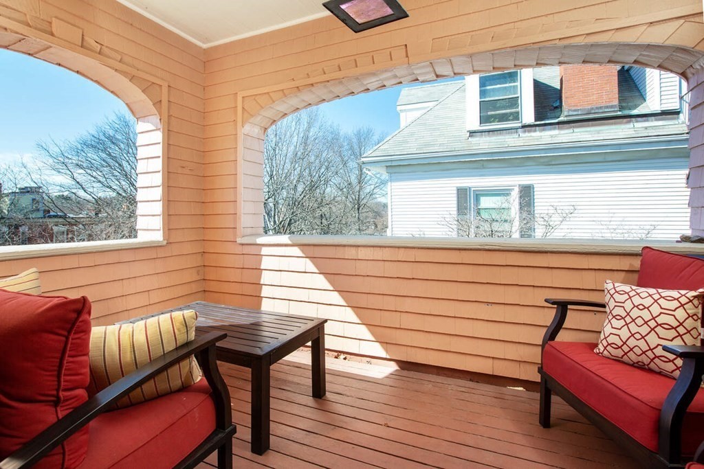 145 Salisbury Road, Unit 145 Brookline, MA 02445 - Photo 8 of 17 a view of a wooden chairs on the deck