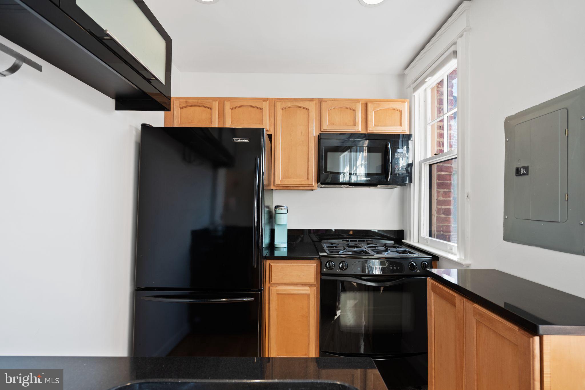 2902 Porter Street Northwest, Unit 43 Washington, DC 20008 - Photo 14 of 31 a kitchen with a refrigerator and a stove