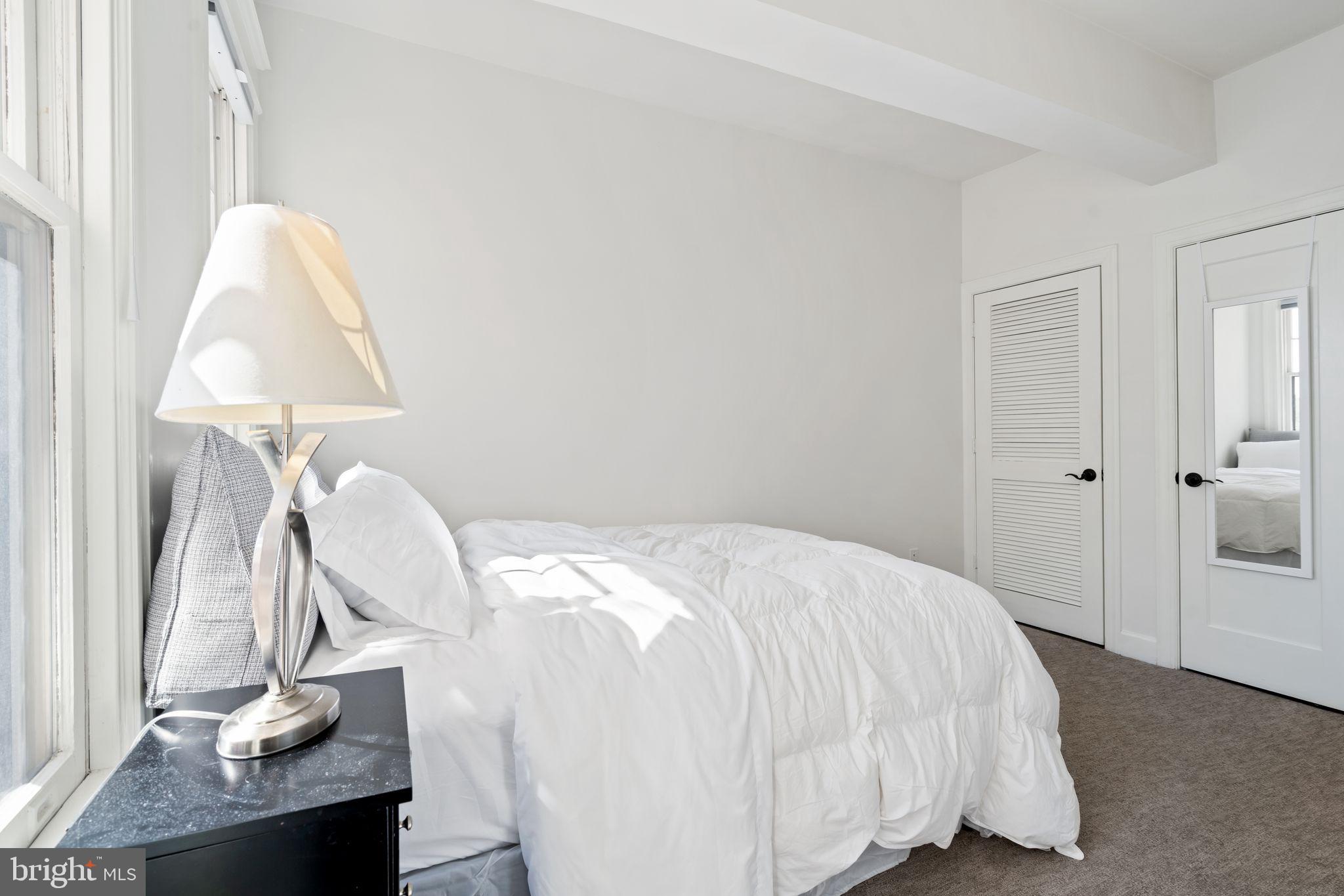 2902 Porter Street Northwest, Unit 43 Washington, DC 20008 - Photo 15 of 31 a bed room with a bed and a lamp