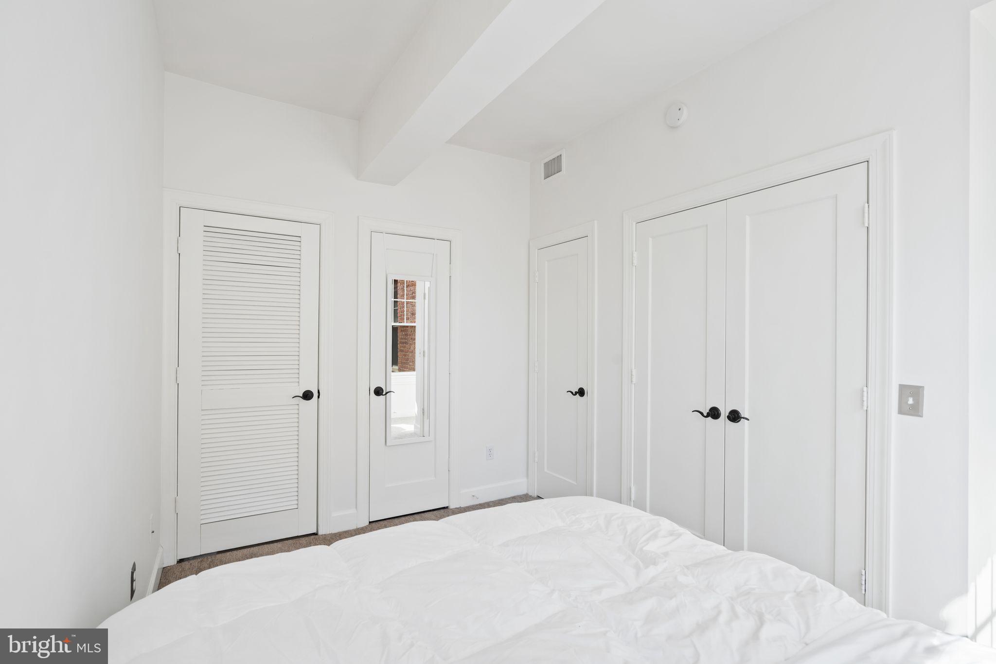 2902 Porter Street Northwest, Unit 43 Washington, DC 20008 - Photo 18 of 31 a bedroom with a bed and a shower