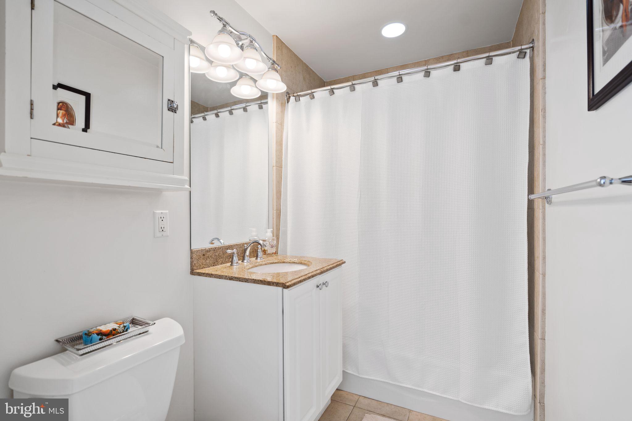 2902 Porter Street Northwest, Unit 43 Washington, DC 20008 - Photo 21 of 31 a bathroom with a sink and a mirror