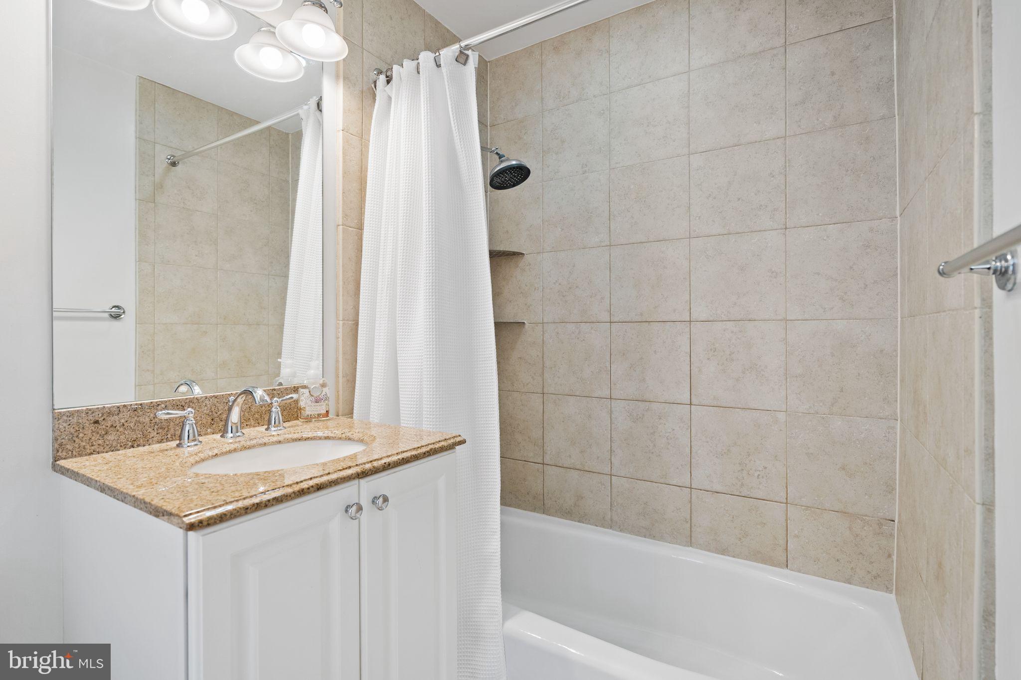 2902 Porter Street Northwest, Unit 43 Washington, DC 20008 - Photo 22 of 31 a bathroom with a sink and a mirror