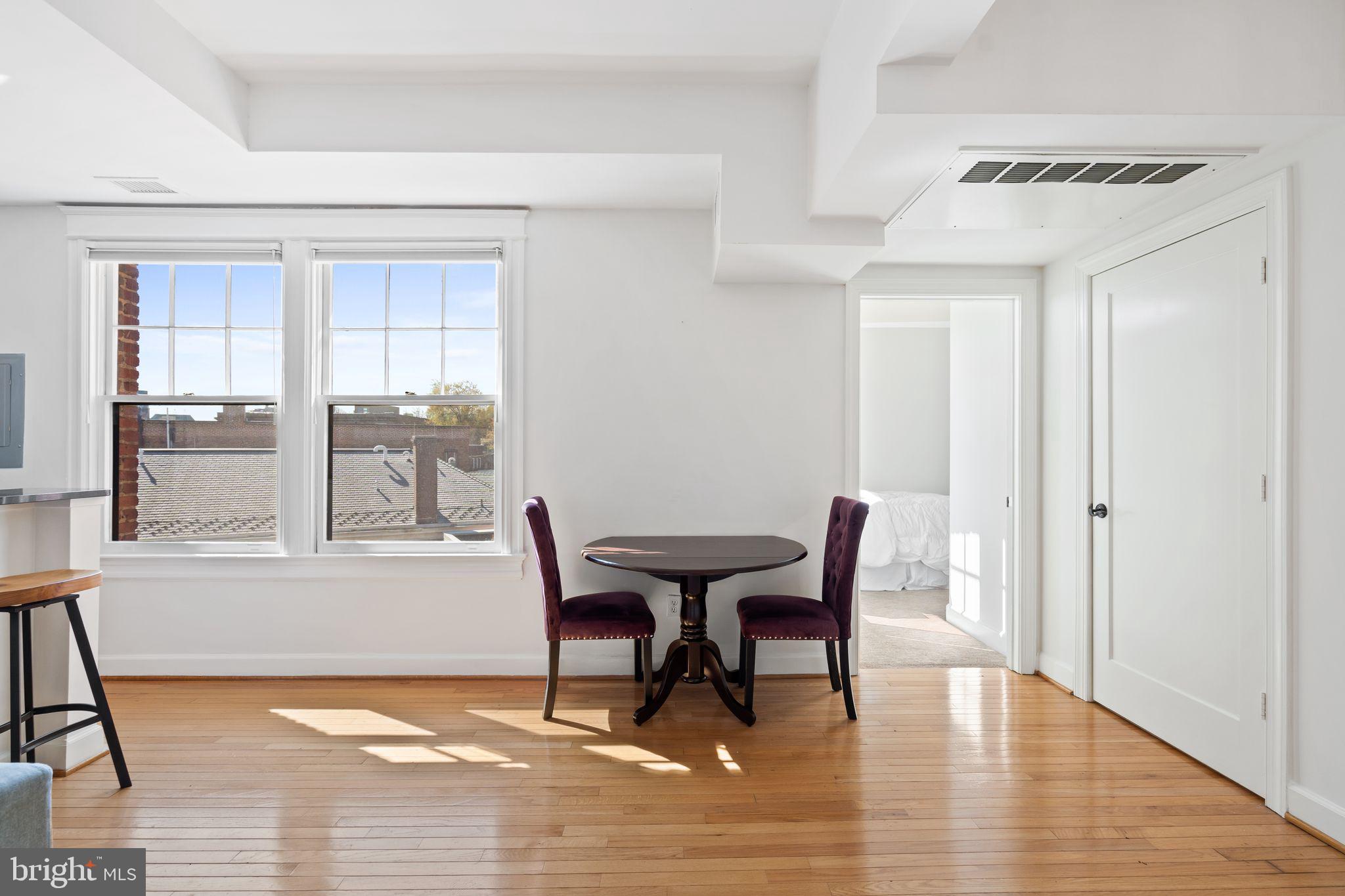 2902 Porter Street Northwest, Unit 43 Washington, DC 20008 - Photo 7 of 31 a view of a dining room with furniture and wooden floor
