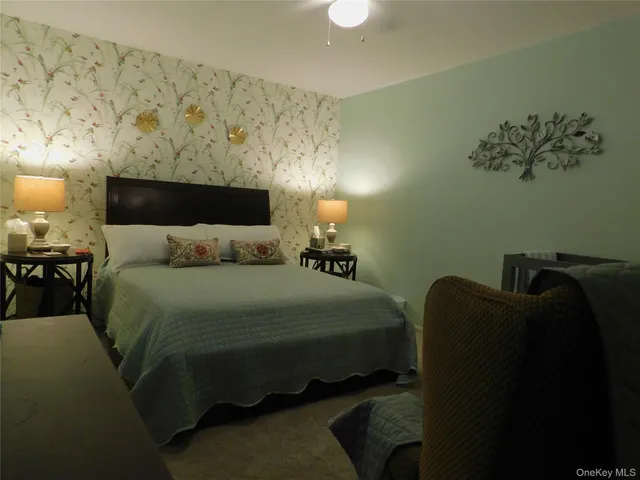 a bedroom with a bed and a painting on the wall