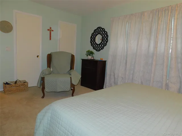 a bedroom with a bed and a chair