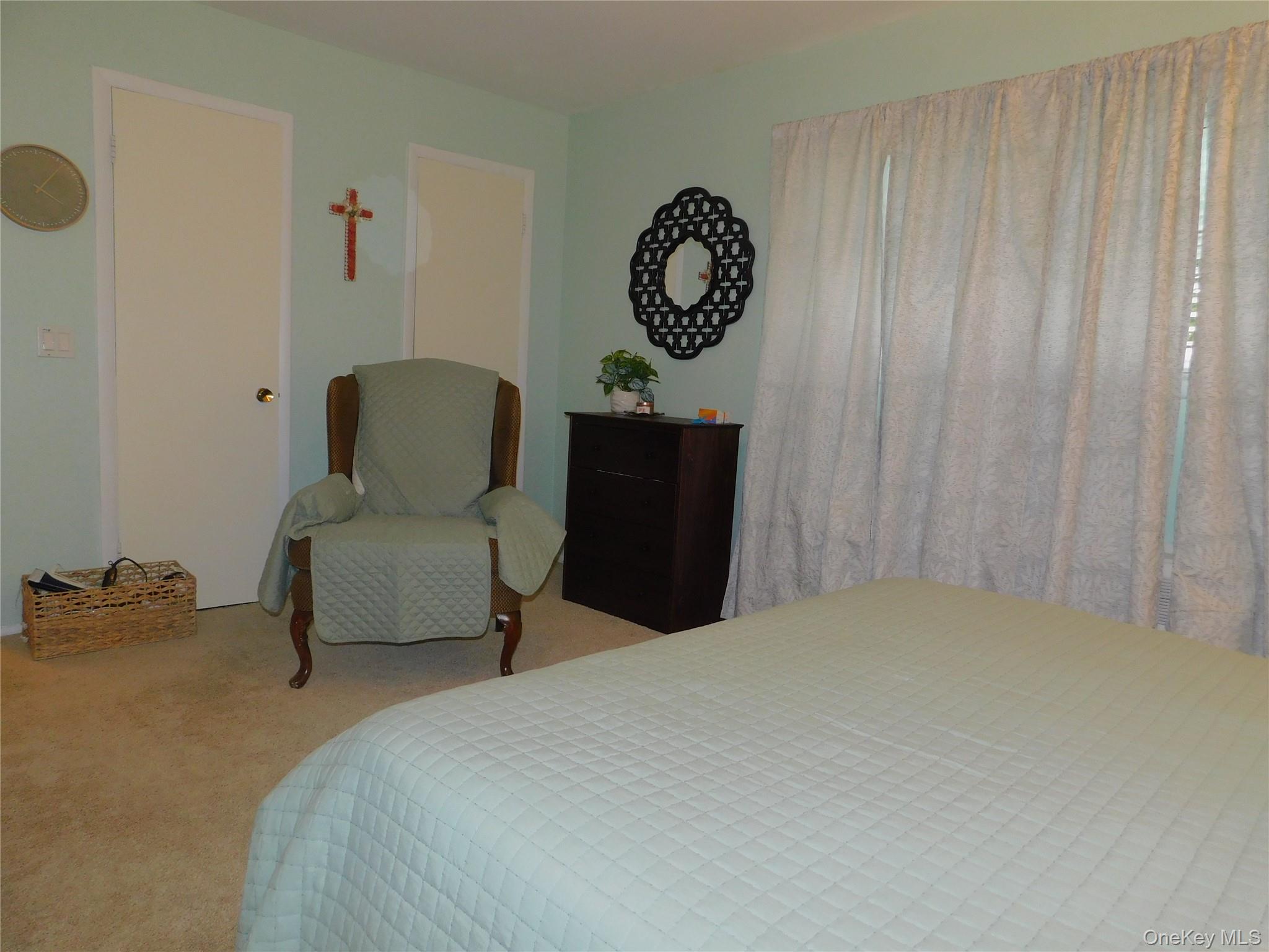 1879 Crompond Road, Unit #D15 Peekskill, NY 10566 - Photo 17 of 24 a bedroom with a bed and a chair