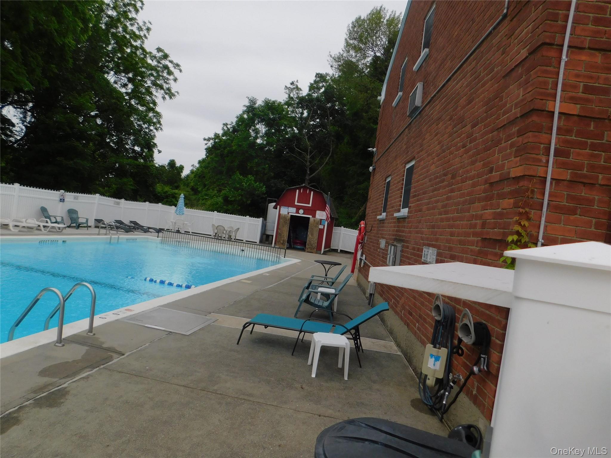 1879 Crompond Road, Unit #D15 Peekskill, NY 10566 - Photo 23 of 24 a view of a chairs and table in the patio