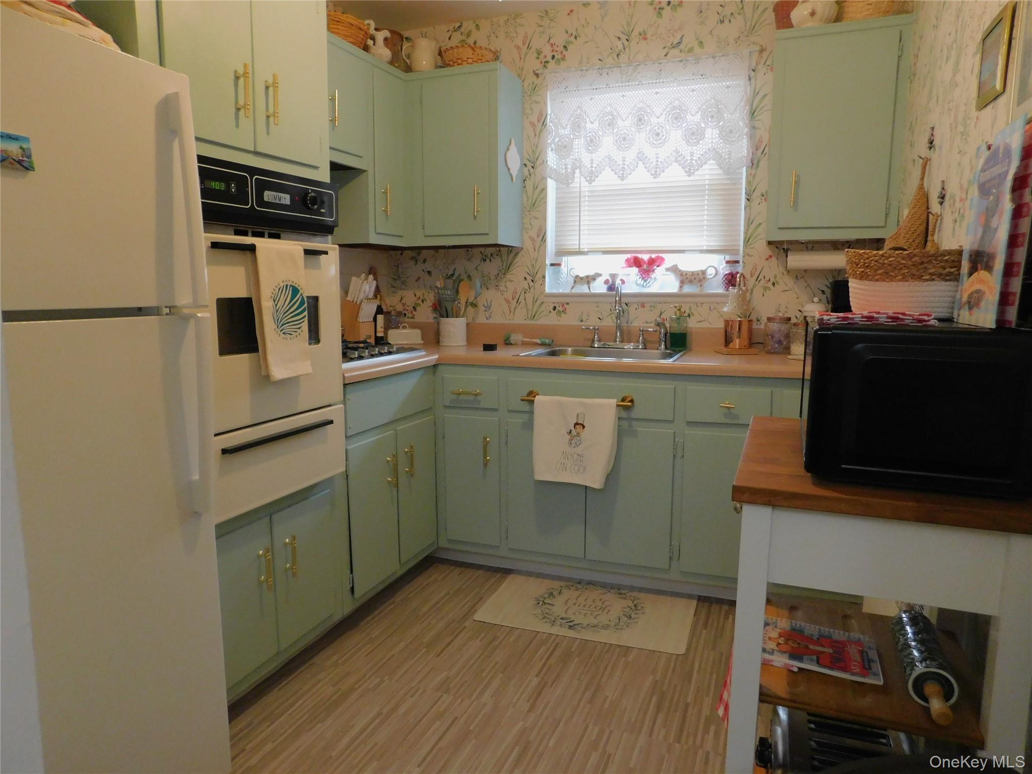 1879 Crompond Road, Unit #D15 Peekskill, NY 10566 - Photo 3 of 24 a kitchen with granite countertop a sink stove and refrigerator