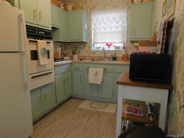 a kitchen with a sink appliances and cabinets