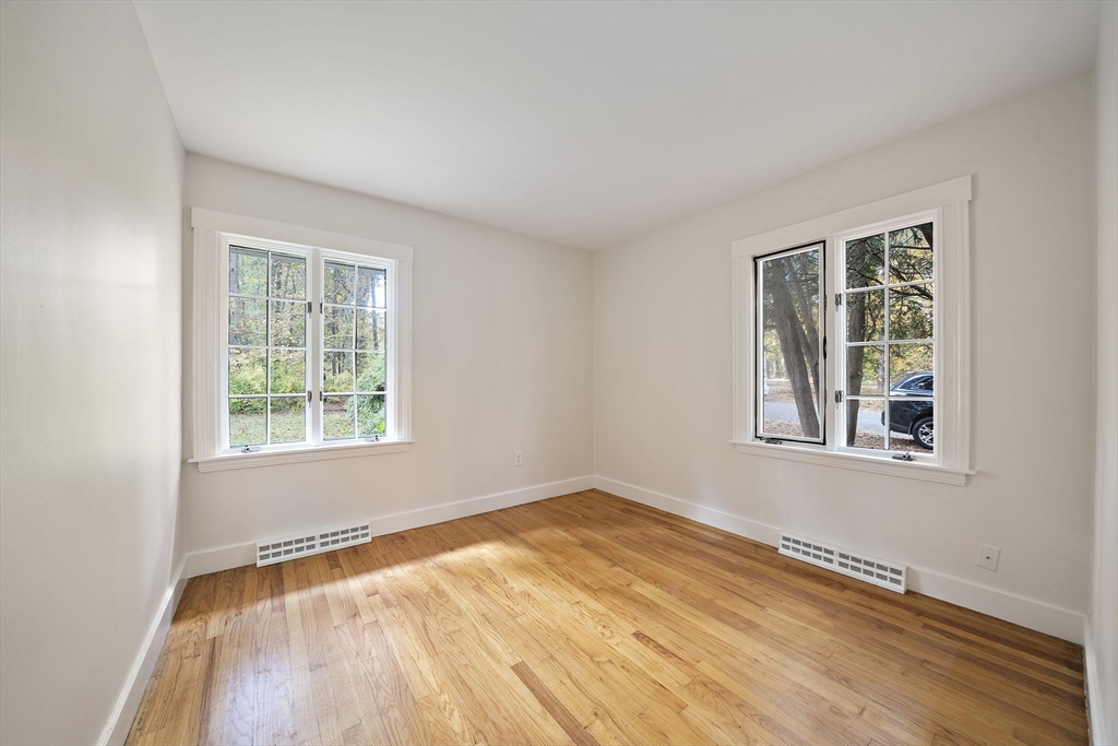 24 Sagamore Street Hamilton, MA 01982 - Photo 14 of 37 an empty room with wooden floor and windows