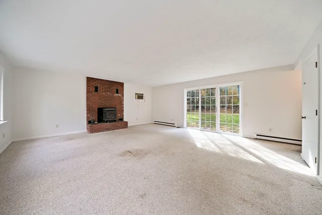 a view of empty room with a fireplace