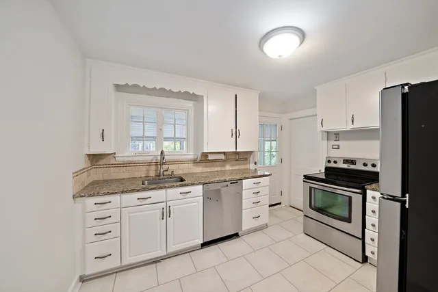 a kitchen with cabinets stainless steel appliances and a sink