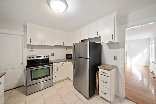 a kitchen with a refrigerator sink and cabinets