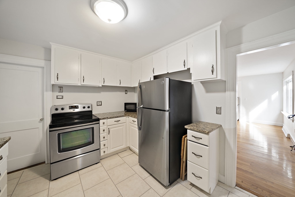 24 Sagamore Street Hamilton, MA 01982 - Photo 5 of 37 a kitchen with a refrigerator sink and cabinets