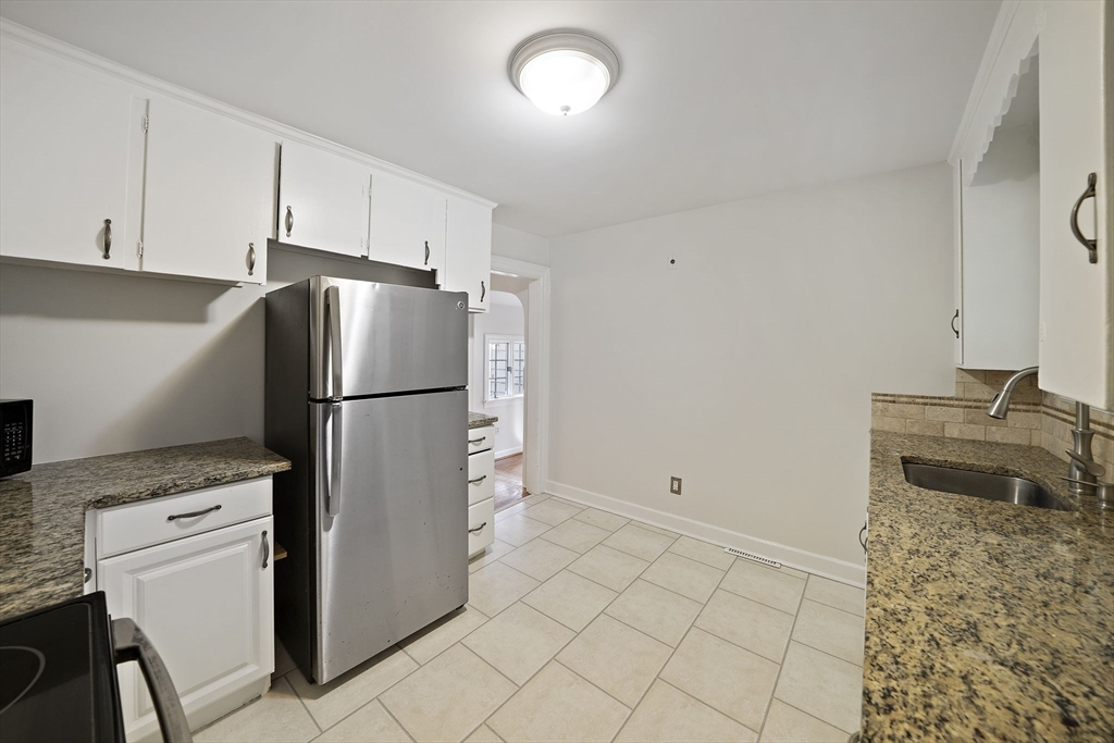 24 Sagamore Street Hamilton, MA 01982 - Photo 6 of 37 a kitchen with a refrigerator sink and cabinets