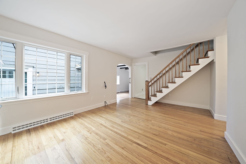 24 Sagamore Street Hamilton, MA 01982 - Photo 10 of 37 a view of an empty room with wooden floor and a window