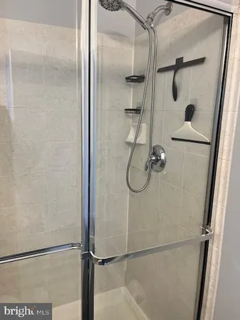 a bathroom with a glass shower door
