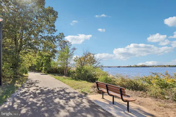 a view of a terrace with a bench and lake view