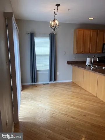 a view of a kitchen with a sink and cabinets