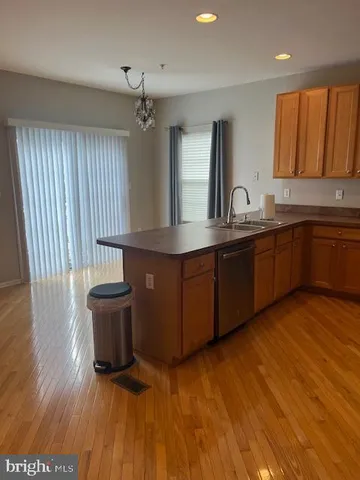 a view of kitchen with granite countertop cabinets and wooden floor