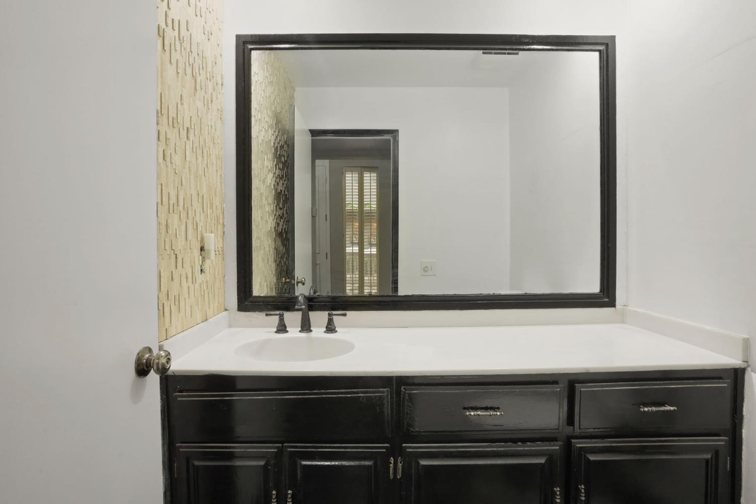 1917 Edgebrook Drive, Unit D Modesto, CA 95354 - Photo 11 of 58 a bathroom with a sink and a mirror
