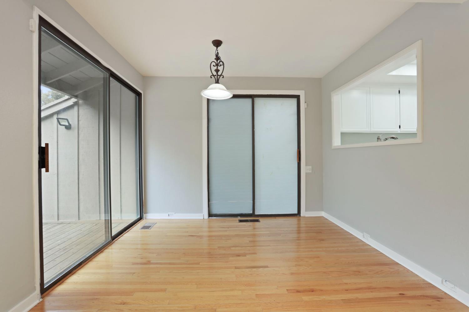1917 Edgebrook Drive, Unit D Modesto, CA 95354 - Photo 17 of 58 a view of empty room with wooden floor and fan
