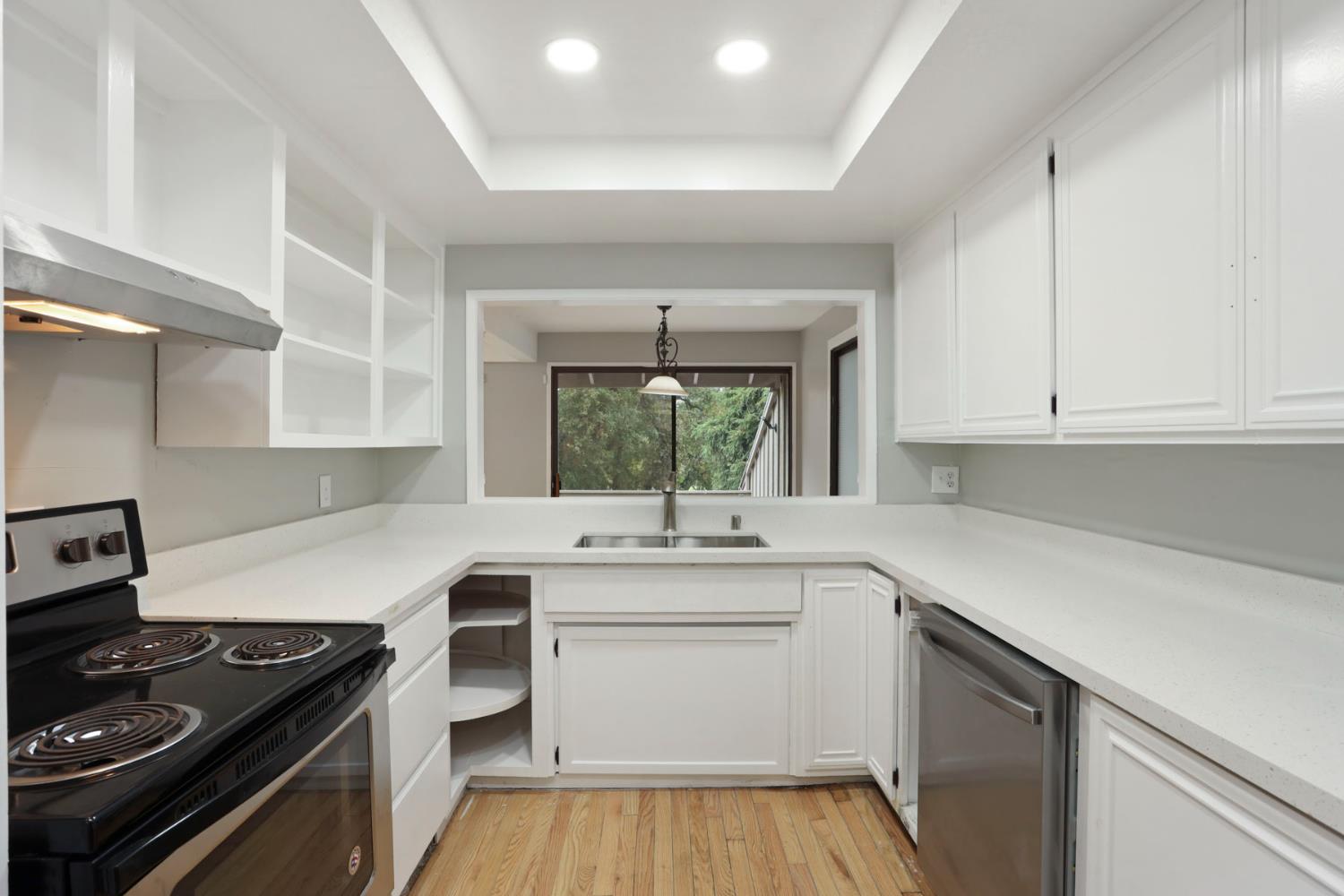 1917 Edgebrook Drive, Unit D Modesto, CA 95354 - Photo 23 of 58 a kitchen with a sink stove top oven and cabinets